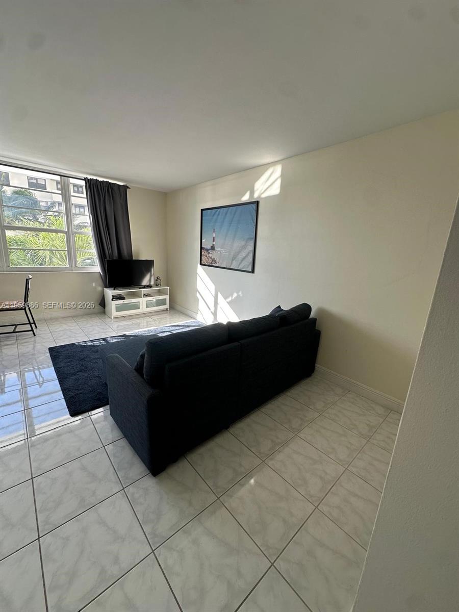 100 Lincoln Road, Unit 532 Miami Beach, FL 33139 - Photo 5 of 12 a living room with a couch and a flat screen tv