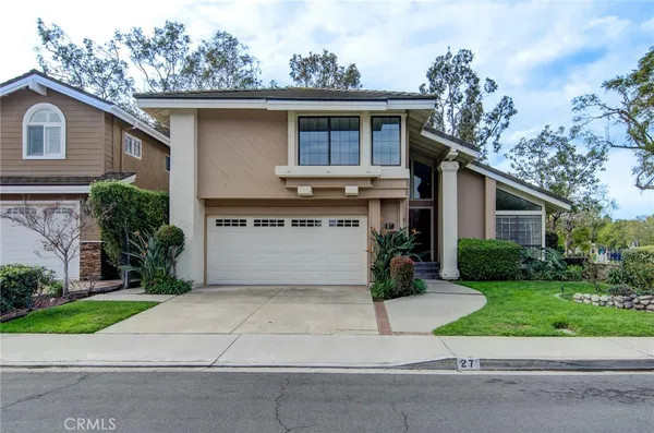 a view of a house with a yard and plants