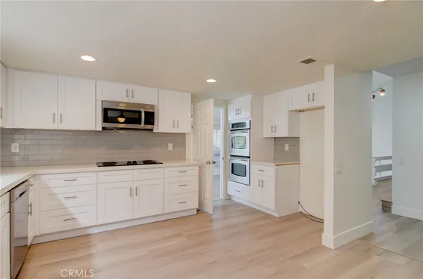 a kitchen with stainless steel appliances a refrigerator sink and stove