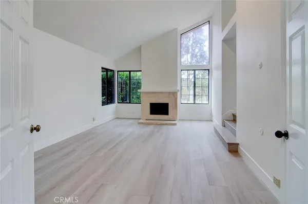 wooden floor in an empty room with a fireplace