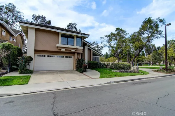 a front view of house with yard and green space