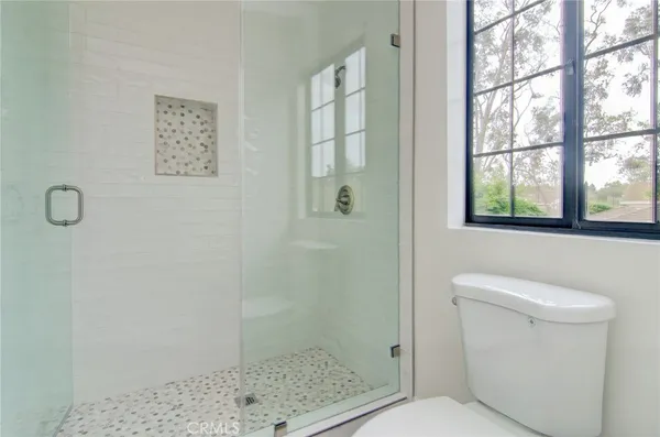 a bathroom with a toilet and a shower