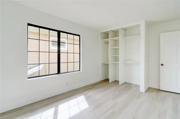 a bathroom with a granite countertop double vanity sink and mirror