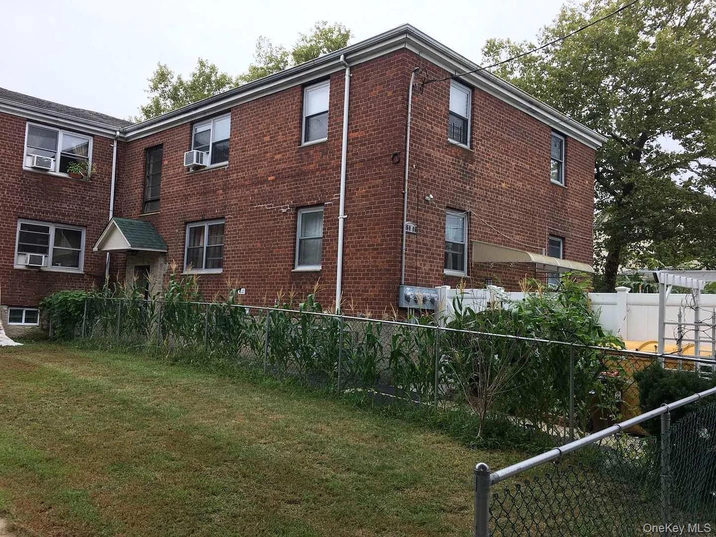 160-06 75th Road, Unit 3 Queens, NY 11366 - Photo 2 of 3 a front view of a house with balcony