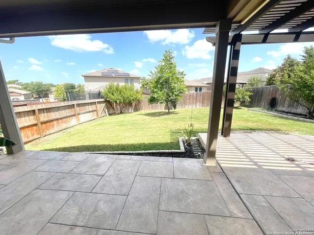 a view of a room with wooden floor and a yard