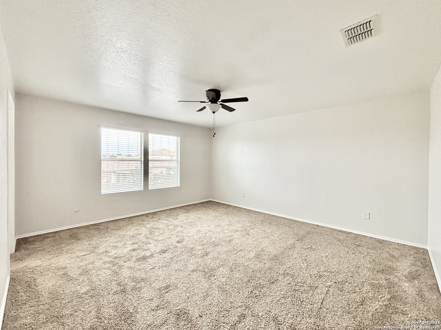 9358 Fisherman Converse, TX 78109 - Photo 10 of 22 an empty room with a window and a ceiling fan