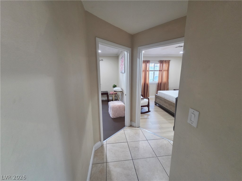 3381 Westwind Road Las Vegas, NV 89146 - Photo 47 of 52 A well-lit hallway connects inviting rooms, each with distinct flooring, creating a fluid and functional interior.