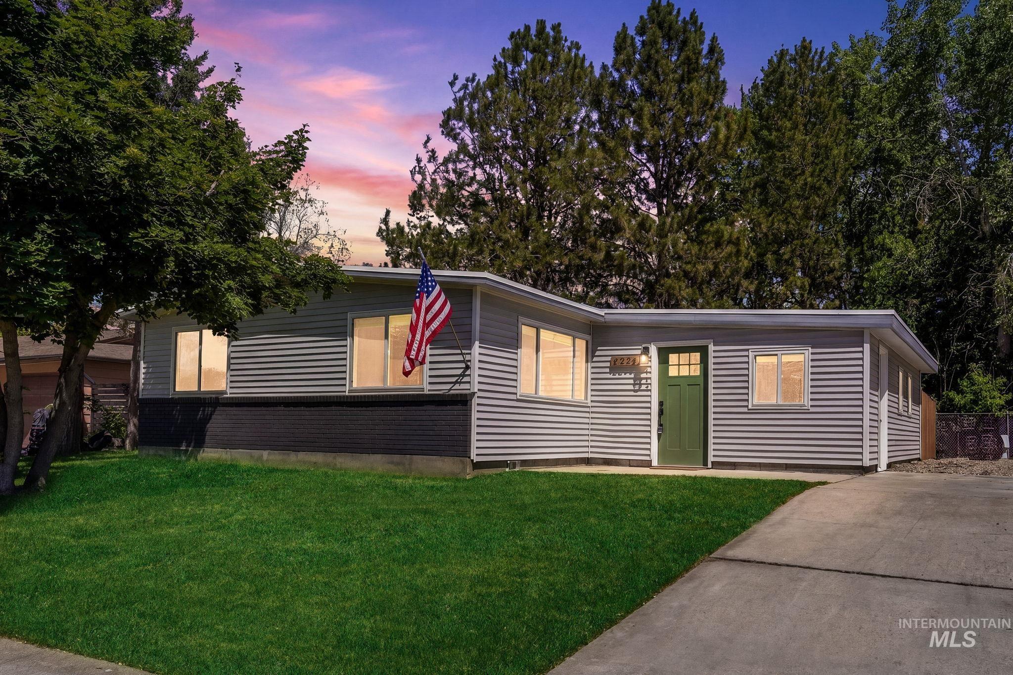 2224 Rachel Circle Boise, ID 83706 - Photo 2 of 50 Contemporary single-story residence with horizontal siding, a contrasting dark foundation, and a vibrant green entry door