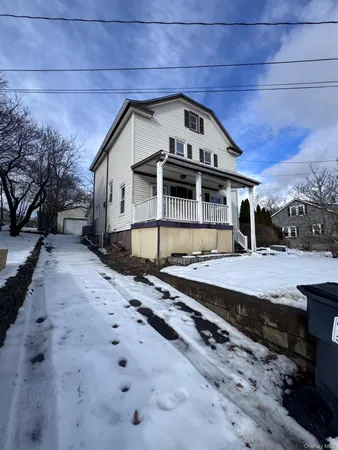 a view of a large white house with a yard