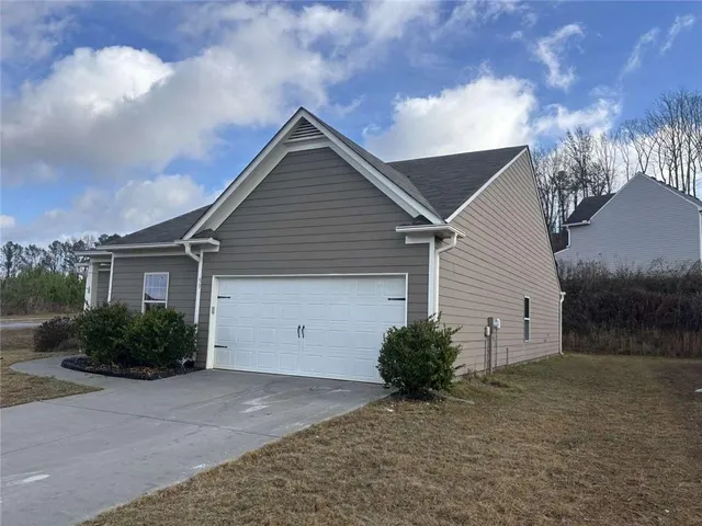 a view of a house with a yard and garage