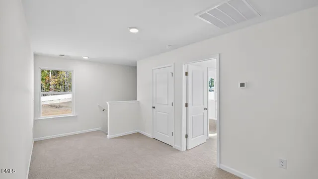 an empty room with windows and closet