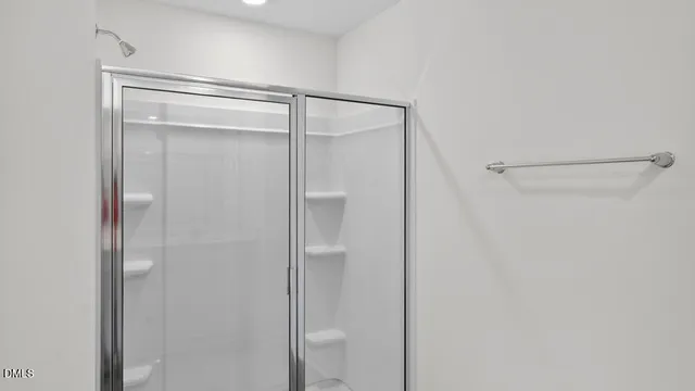 a bathroom with a glass shower door