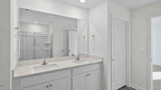 a bathroom with double sink and a mirror