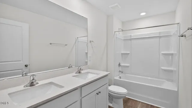 a bathroom with a sink toilet tub and shower