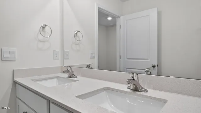 a bathroom with a sink and a large mirror