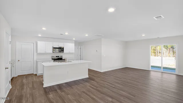 a view of kitchen with wooden floor and electronic appliances