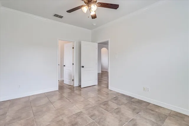 wooden floor in an empty room with a chandelier fan