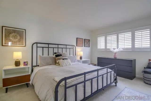 a bedroom with a large bed and a window