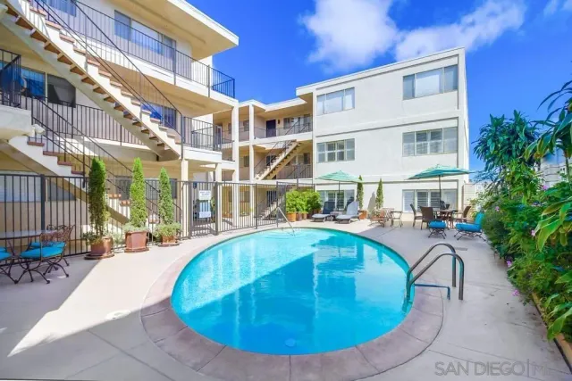 a view of a swimming pool with outdoor seating
