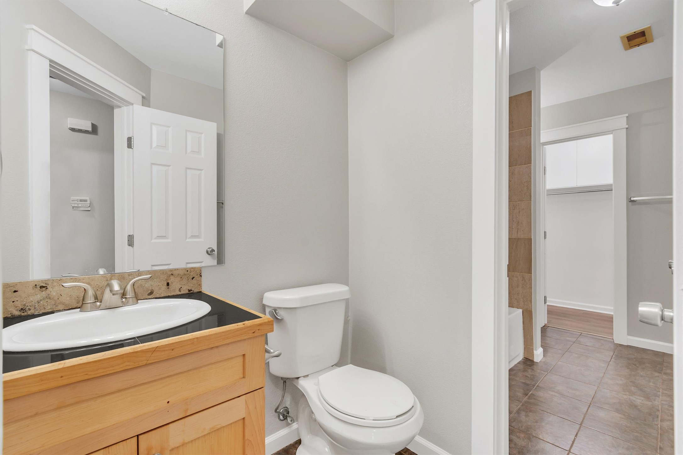 720 Decker Prairie Drive Austin, TX 78748 - Photo 16 of 21 Full bath with vanity, a spacious closet, and tile patterned floors