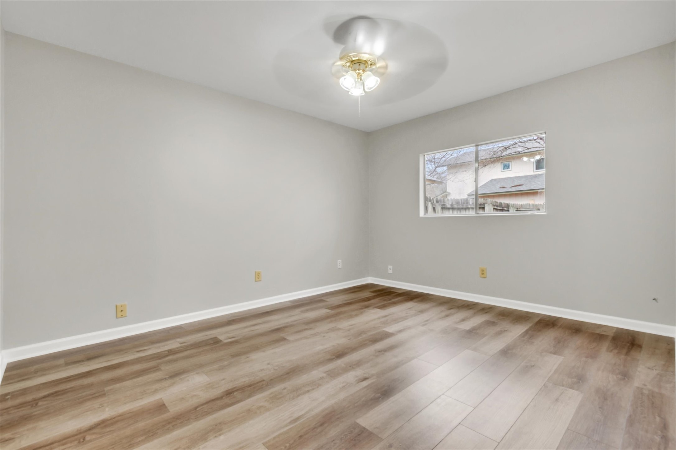 720 Decker Prairie Drive Austin, TX 78748 - Photo 17 of 21 Unfurnished room featuring light wood finished floors and ceiling fan