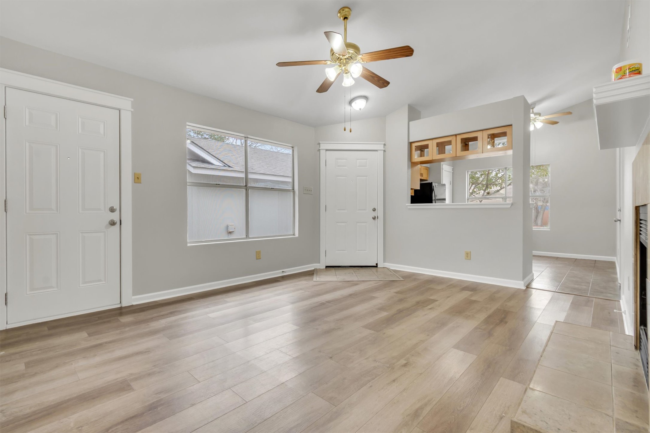 720 Decker Prairie Drive Austin, TX 78748 - Photo 6 of 21 Foyer with a fireplace, light wood-type flooring, and ceiling fan