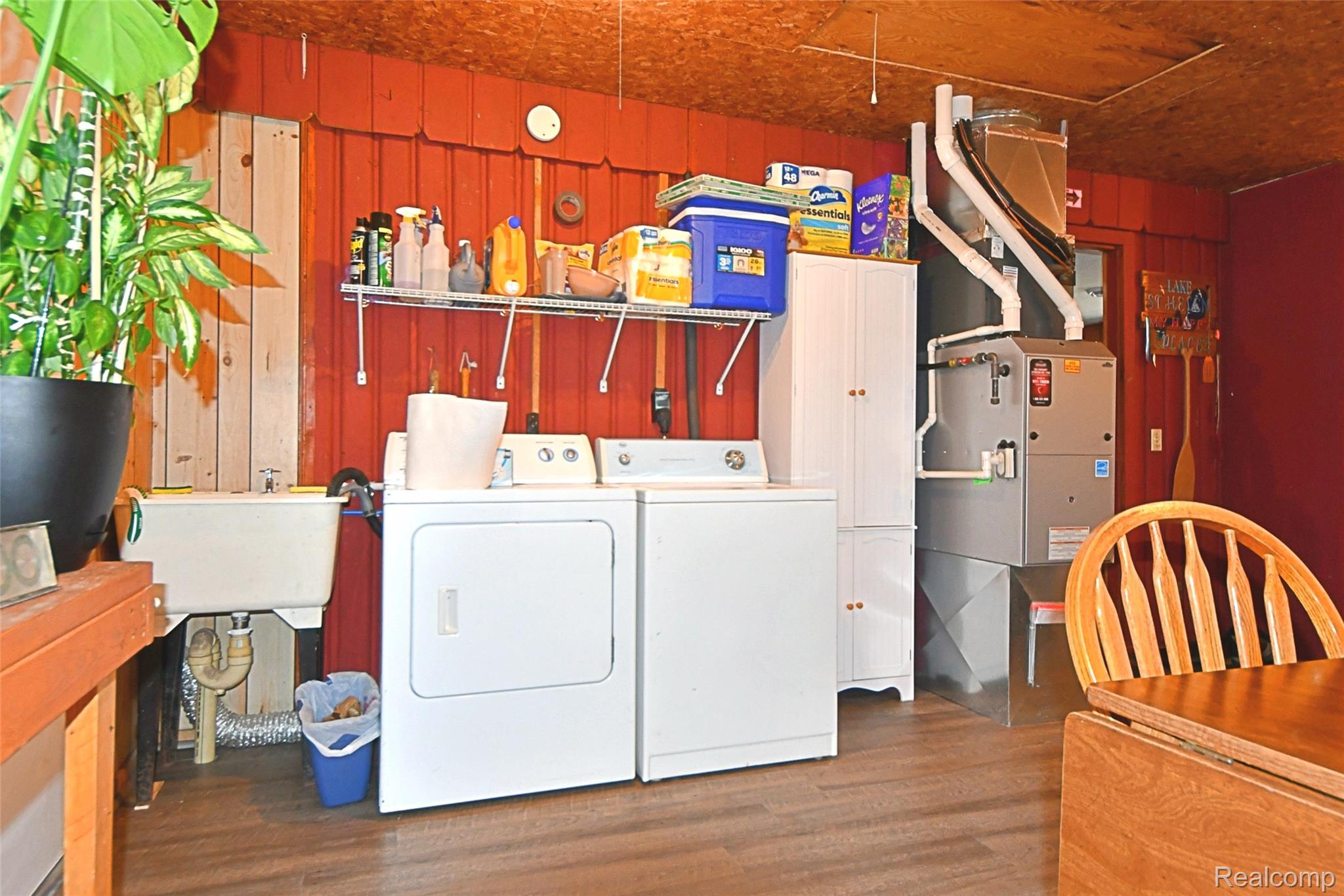 10456 Austin Road St. Helen, MI 48656 - Photo 17 of 24 Laundry area featuring wood finished floors, wooden walls, and washer and dryer