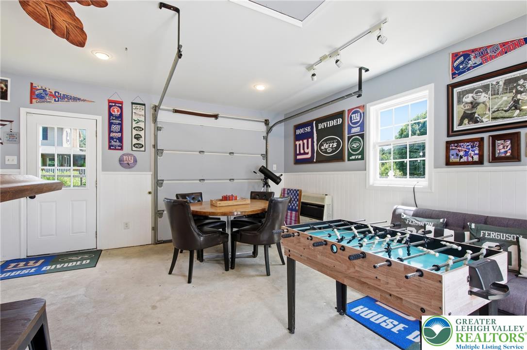 890 Lahr Road Nazareth, PA 18064 - Photo 42 of 71 A well-lit garage conversion creates a lively entertainment zone, featuring recessed and track lighting with a window view.
