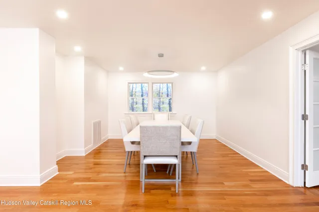 a dining room with furniture and wooden floor