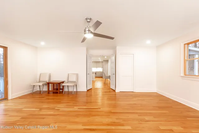a view of a living room a kitchen with a table and chairs