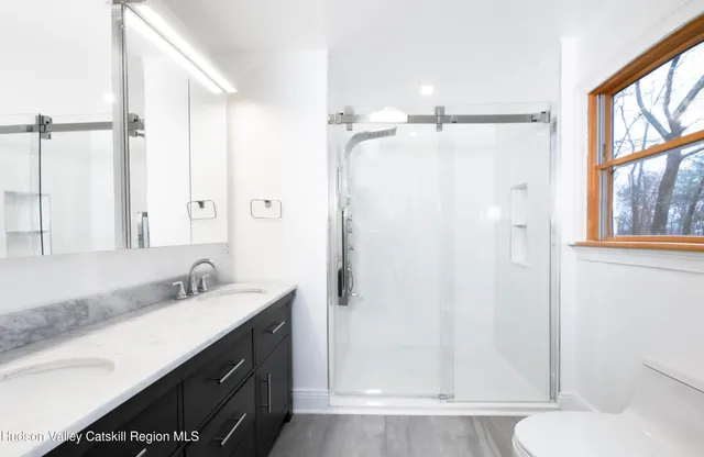 a view of a hallway with wooden floor and stairs