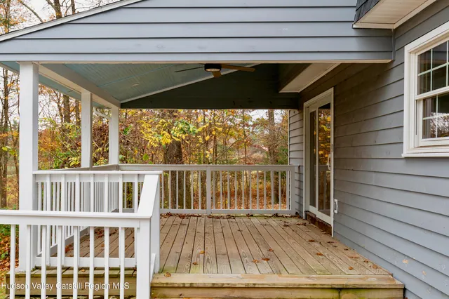 a view of balcony with double vanity and trees
