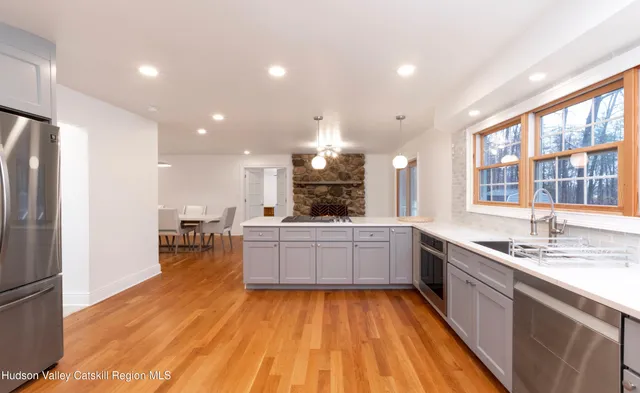 a large kitchen with a large window and stainless steel appliances