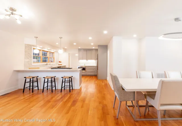 a dining room with furniture and wooden floor
