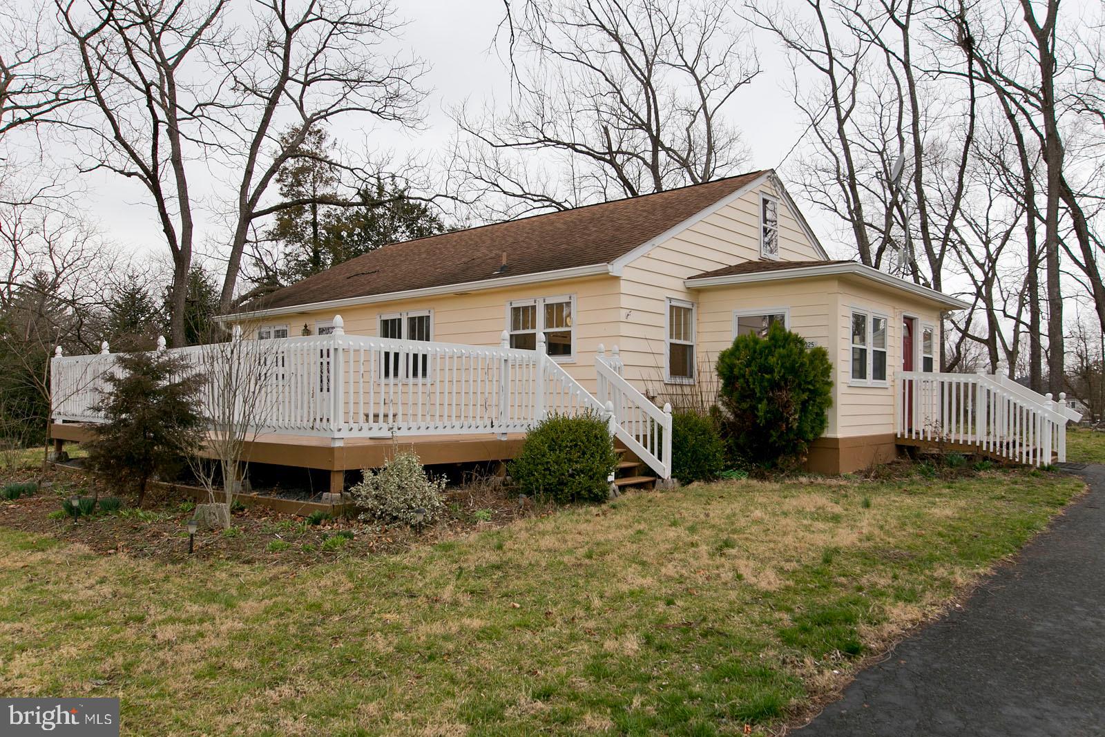 a view of a house with a yard and sitting area