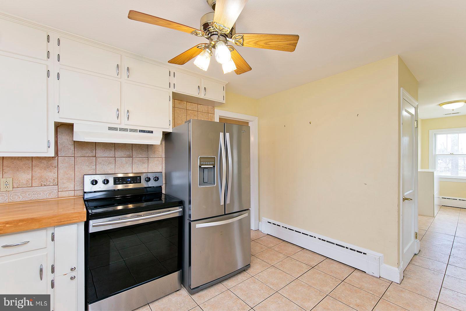 325 Berrys Ferry Road White Post, VA 22663 - Photo 14 of 60 a kitchen with granite countertop a refrigerator and a stove top oven