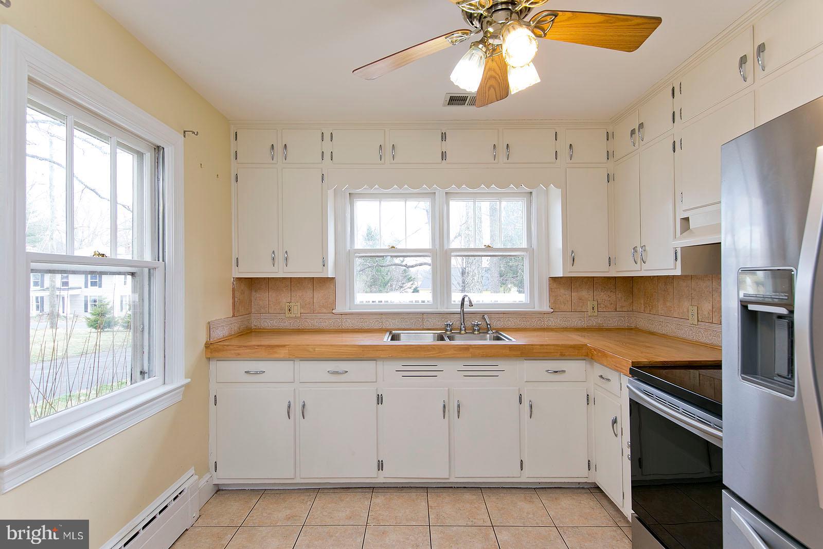 325 Berrys Ferry Road White Post, VA 22663 - Photo 16 of 60 a kitchen with a sink window and cabinets