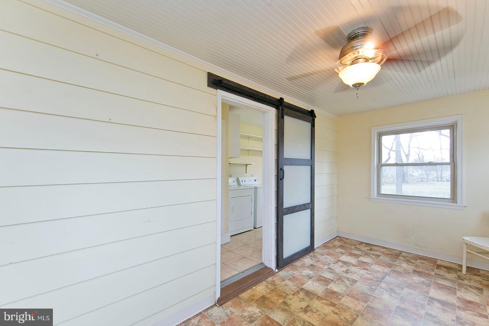 325 Berrys Ferry Road White Post, VA 22663 - Photo 19 of 60 a view of a livingroom with a large window and chandelier fan
