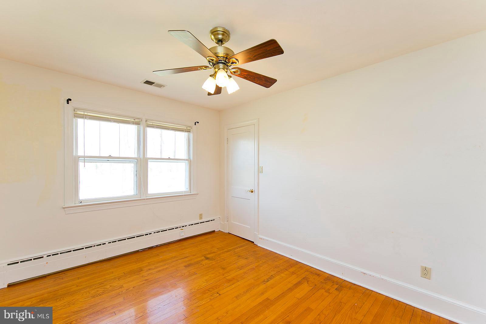 325 Berrys Ferry Road White Post, VA 22663 - Photo 20 of 60 an empty room with windows and fan
