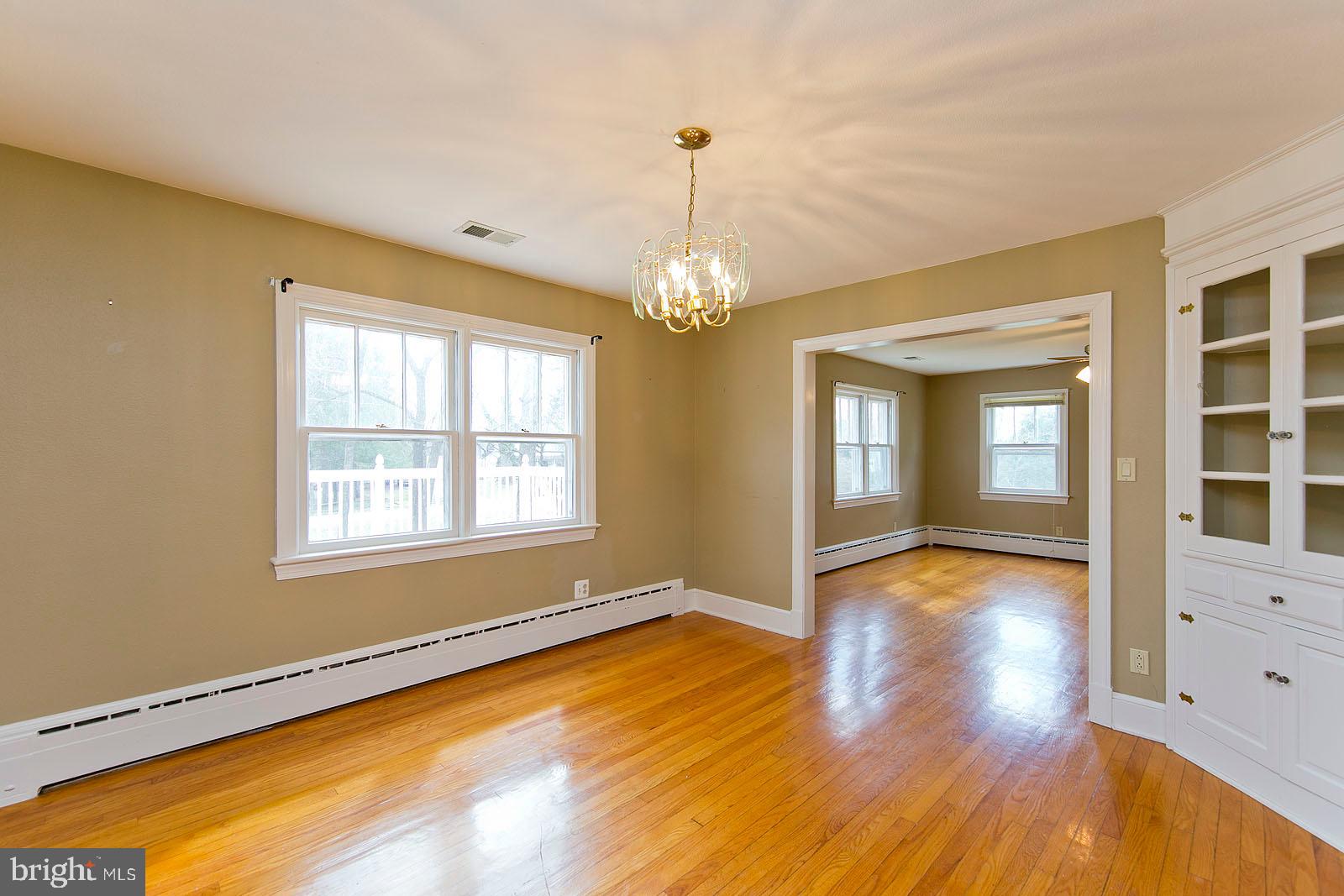 325 Berrys Ferry Road White Post, VA 22663 - Photo 4 of 60 a view of an empty room with wooden floor and a window