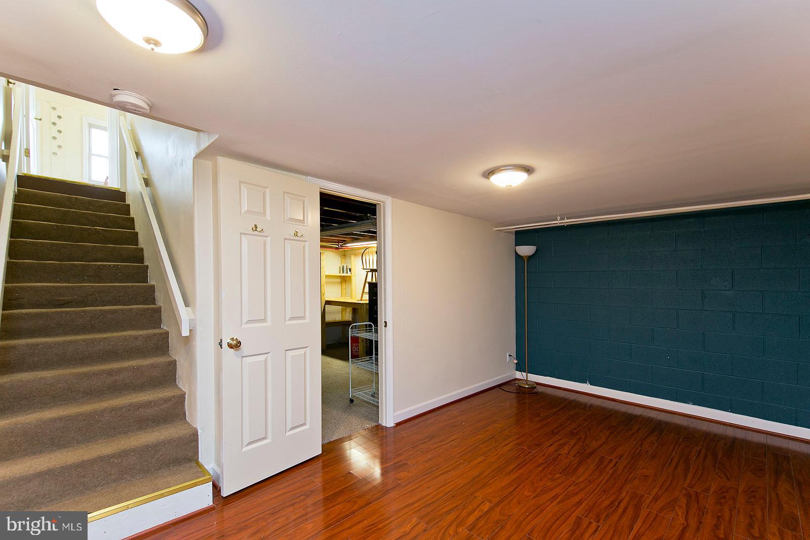 325 Berrys Ferry Road White Post, VA 22663 - Photo 32 of 60 a view of empty room with wooden floor and stairs