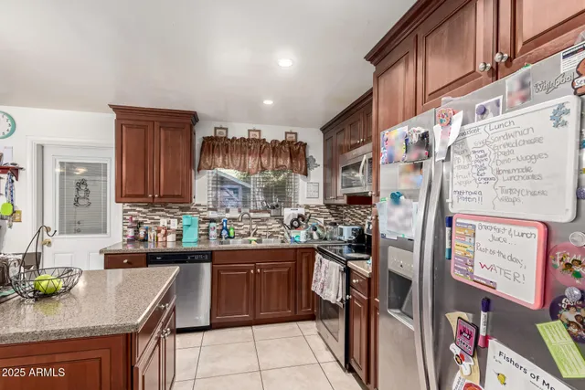 a kitchen with stainless steel appliances granite countertop a stove and cabinets