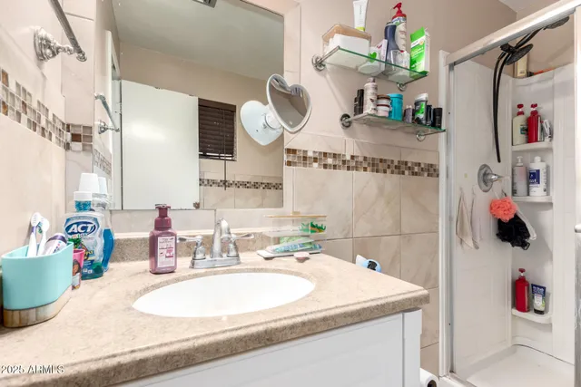 a bathroom with a sink mirror and vanity