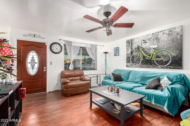 a living room with furniture and a wooden floor