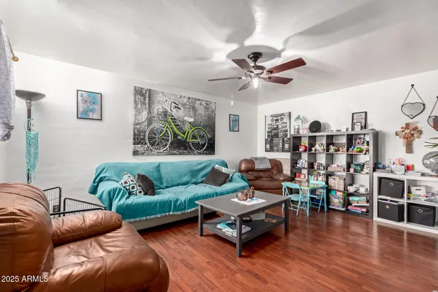 a living room with furniture and wooden floor
