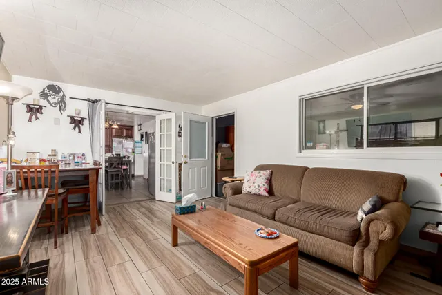 a living room with furniture and a wooden floor