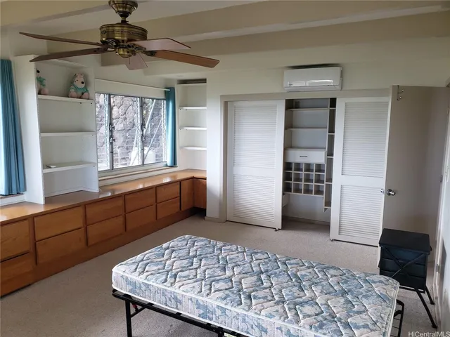 a bedroom with a bed and a dresser