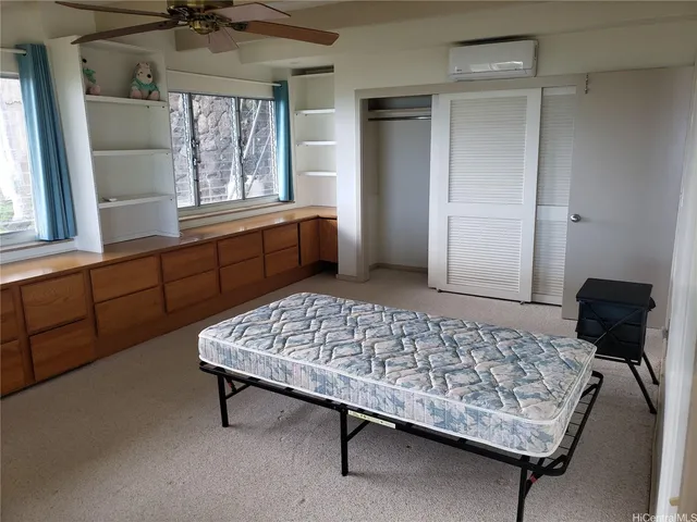 a bedroom with a bed and window