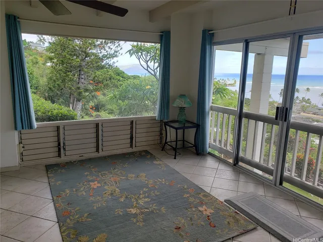 a view of a room with furniture and a large window