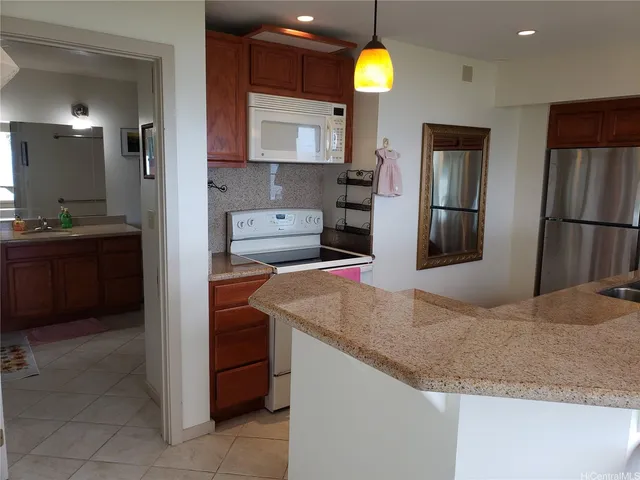 a kitchen with stainless steel appliances granite countertop a sink refrigerator and microwave